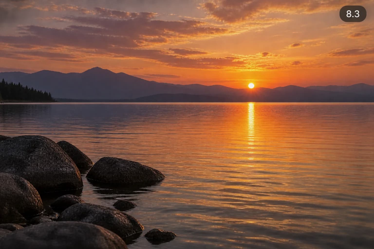 Sunset over a calm mountain lake, foreground rocks and a score label of 8.3
